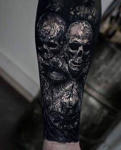 a man's arm with two skulls on it