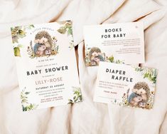 two baby shower cards with hedges on them sitting on a white bed sheet next to each other