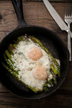 an egg and asparagus dish in a skillet