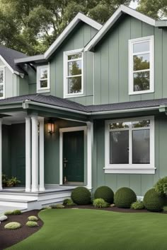 a green house with white trim and windows