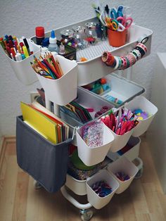 the cart is filled with lots of office supplies and stationery on it's wheels