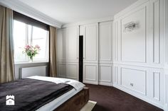 a bedroom with white walls and brown carpet