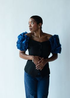 "Sculptural 1980s - early 90s black blouse by A.J. Bari with off the shoulder blue puff sleeves, a subtle v-neckline and satin covered buttons at the front. Boning at sides for structure. Fully lined. 50% acetate 50% polyester.  - Size Small / Medium - Bust: 34\" - 36\"  Waist: 28\"  Length: 18\"  Condition: Excellent!" Fitted Party Blouse With Structured Shoulders, Fitted Blouse With Structured Shoulders For Party, Puff Sleeve Padded Blouse For Evening, Fitted Party Tops With Structured Shoulders, Party Tops With Structured Shoulders And Fitted Style, Fitted Tops With Structured Shoulders For Party, Fitted Blue Puff Sleeve Top, Chic Fitted Puff Sleeve Top For Evening, Fitted Padded Puff Sleeve Top For Evening