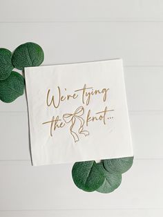 a piece of paper with the words we're trying to break on it next to some green leaves