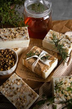 soap bars with herbs and honey sit on a table