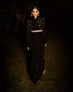 Editor's Note Featuring a black pre-draped saree with ruffle trim on border. It comes with hand embroidered peplum blouse and embroidered belt. Fabric: Silk and tissue Color: Black Sleeves: Full Component: Sari, peplum blouse and belt Occasion: Festive Disclaimer: Product colour may slightly vary due to photographic lighting sources Care: Dry Clean Only About the Designer Matsya by Utkarsh Ahuja curated for the princess in disguise, royal humility at the heart of a simple life lived in the stren Black Dresses With Cape Sleeves For Reception, Black Cape Sleeve Dress For Reception, Evening Anarkali Blouse With Traditional Drape, Black Anarkali Style Embellished Pre-draped Saree, Black Embellished Blouse With Traditional Drape, Black Embellished Georgette Blouse, Black Pre-draped Saree For Formal Occasions, Formal Black Pre-draped Saree, Black Embellished Pre-draped Saree For Designer Wear