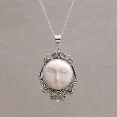 The staring face of a glowing moon is carved by hand of smooth cowbone to center the pendant of this impressive Balinese necklace. Made Wardika presents the necklace which is elaborated with sterling silver designs that surround the moon's face. The pendant is accented with a petite peridot gemstone. Glowing Moon, Trending Jewelry, Peridot Pendant, Bone Pendant, Leather Corded Necklace, Moon Pendant Necklace, Tiffany Jewelry, Printed Jewelry, Turtle Pendant