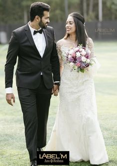 a bride and groom walking hand in hand