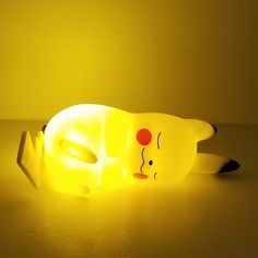 a yellow light that is shaped like a dog with its head turned to the side