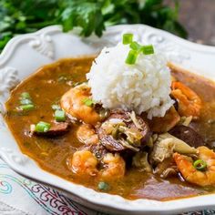 a white plate topped with rice and shrimp