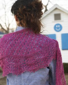 a woman wearing a pink knitted shawl