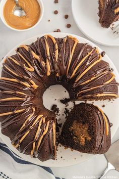 a chocolate bundt cake with caramel drizzled on top and one slice cut out