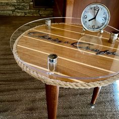 a clock sitting on top of a wooden table