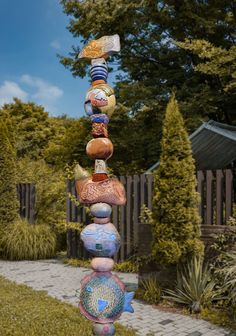 a sculpture made out of rocks in the middle of a garden