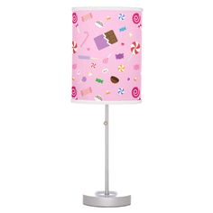 a pink table lamp with candy and lollipops on the lampshade