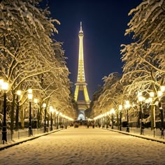 the eiffel tower lit up at night in paris, france with snow on the ground