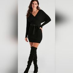 Wrap Yourself In The Cozy Elegance Of This Long-Sleeve Mini Sweater Dress. The Dress Features A Flattering Wrap Design With A Side Tie That Cinches At The Waist, Enhancing Your Silhouette. Crafted From A Soft Ribbed Knit Fabric, It Offers Both Warmth And Style, Making It Perfect For Chilly Days. The Plunging V-Neckline Adds A Touch Of Allure, While The Dolman-Shaped Sleeves Maintain A Chic And Sophisticated Look. Ideal For Any Autumn Or Winter Occasion, This Sweater Dress Pairs Beautifully With Black V-neck Sweater Dress For Evening, Winter Going Out Mini Dress With V-neck, Black V-neck Sweater Dress For Party, Chic Black V-neck Sweater Dress, V-neck Sweater Dress For Winter Nights, Black V-neck Sweater Dress For Night Out, Black Sweater Dress For Date Night In Fall, Mini Sweater, Knit Tie