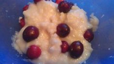 cranberries and cream in a blue bowl