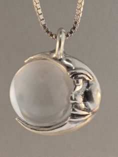 This whimsical Moon Orb is cast in solid sterling silver and is 3/4" high including the bail for the chain. The Crescent Moon wears a gentle smile, encircles a 12mm orb and is completely three dimensional. Please select your orb of choice. You may choose between natural clear quartz crystal, black onyx, or for an additional price a black South Sea Pearl.All Marty Magic Charms and Pendents include an 18 inch (46cm) box chain. If you would prefer a different length of chain please feel free to con Sterling Silver Moon Jewelry, Mystical Round Sterling Silver Necklace, Mystical Sterling Silver Round Necklace, Sterling Silver Moon Charm Jewelry, Moon Jewelry Silver, Silver Moon-shaped Magical Necklace, Silver Moon-shaped Crystal Necklace For Gifts, Mystical Silver Moon-shaped Crystal Necklace, Whimsical Moon