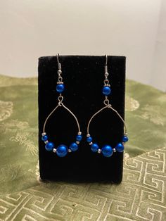 Wire loop adorned with blue round beads. All wire is nickel free. Bead Hoop Earrings, Beaded Earrings Diy, Earrings Diy, Beaded Hoop Earrings, Beaded Hoops, May 31, Blue Beads, Diy Earrings, Round Beads