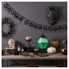 a table topped with lots of different types of halloween decorations and decorating items on top of it