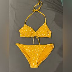 Spotted, Gold/Mustard Bikini. Never Worn, New Condition. Top Is Size Medium, Bottoms Are Size Large. Mustard Swimwear For Summer Poolside, Mustard Swimwear For Poolside In Summer, Mustard Swimwear For Summer Beach, Mustard Swimwear For Beach Season, Mustard Swimwear For Vacation Beach Season, Mustard Beachwear Swimwear For Vacation, Mustard Fitted Swimwear For Summer, Fitted Mustard Swimwear For Summer, Fitted Mustard Summer Swimwear