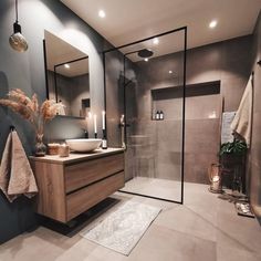 a bathroom with a sink, mirror and shower stall in the middle of the room