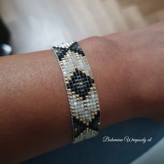 a close up of a person's arm wearing a bracelet with beads on it