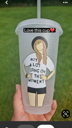 someone holding up a plastic cup with an image on the side and text that reads, love this cup not a lot going on the moment