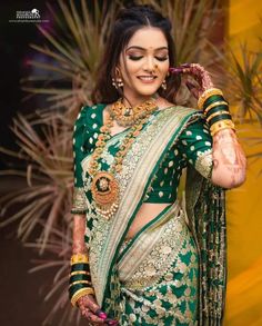 a woman in a green and gold bridal outfit