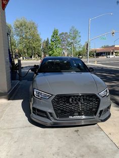 an audi car is parked at a gas station