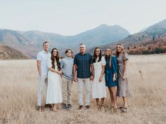 a group of people standing next to each other in a field