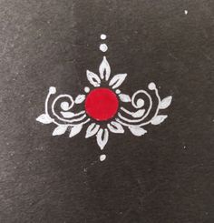 a black surface with white designs and a red circle in the center on top of it