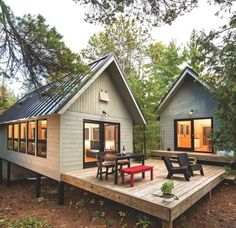 two tiny houses sitting on top of a wooden deck