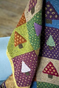 a colorful knitted tie with trees and houses on it