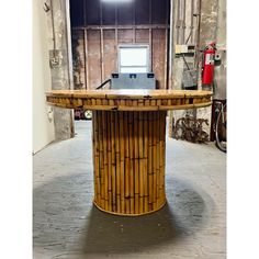 a desk made out of bamboo with a laptop on it in an industrial setting,