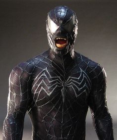 a close up of a spider man with his mouth open