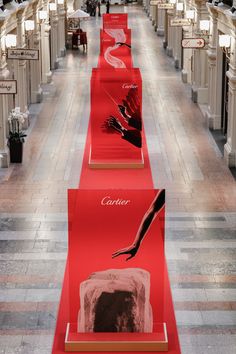 red carpeted walkways lined up with pictures on them