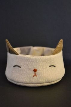 a white cat headband with gold ears