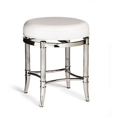 a white stool sitting on top of a wooden table