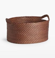 a brown basket with handles on the side