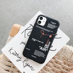 an iphone case sitting on top of a wicker chair next to a pair of scissors