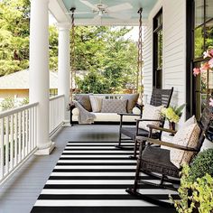 a porch with black and white stripes on the floor