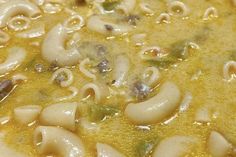 a close up view of some noodles in broth