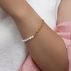 Your inner mermaid is calling! The Pearl Anchor Chain Bracelet is a trendy way to add pearls and gold to your look. This nautical bracelet design features a chunky gold anchor chain split with a string of gorgeous faux pearls. DETAILS & SIZE Composition: 18K gold plated over 316L Stainless Steel; faux pearls Measurements: Chain: 6" + 2" extension Lobster claw clasp Waterproof, tarnish resistant, and lead and nickel free Read about how to care for your jewelry here. Shop our Bracelets for more op Trendy Gold Pearl Bracelet, Gold Pearl Bracelet In Trendy Style, Trendy Pearl Chain Bracelet For Gift, Trendy Pearl Chain Bracelet, Nautical Bracelet, Gold Chain Bracelet, Anchor Chain, Pearl Necklace Set, Pearl Jewelry Sets