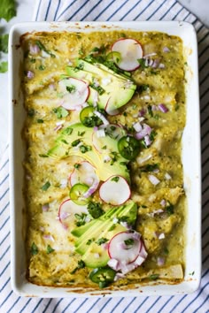 a casserole dish with broccoli, radishes and cucumbers