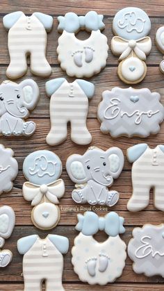 baby shower cookies are arranged on a wooden table