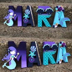 the letters are made out of paper and have mermaids on them