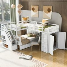 a room with bunk beds, desks and drawers on the floor in front of a large window