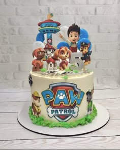 a birthday cake decorated with paw patrol characters